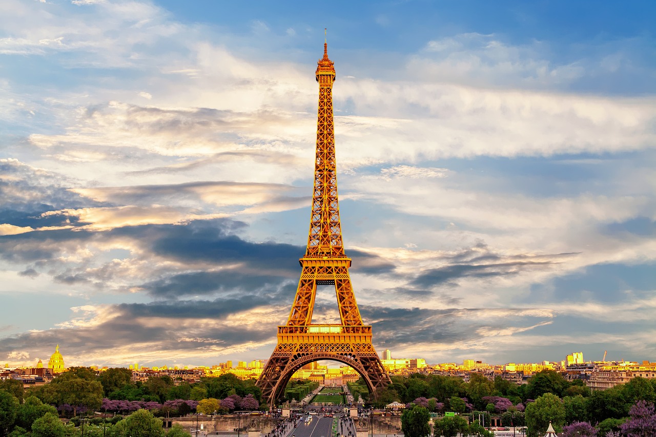 View of the Eiffel Tower in Paris under a clear blue sky, representing travel inspiration.